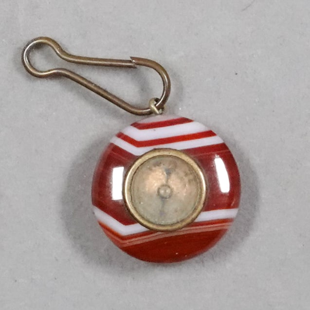 NON-GLASS HANDMADE, Objet d'Vertu. Agate Compass.: NON-GLASS HANDMADE, Objet d'Vertu. Victorian small charm. Handcut antique agate disk with a compass set in the center. Has eyelet. Brass fittings. Germany, circa 1850-1900. 1" diameter .