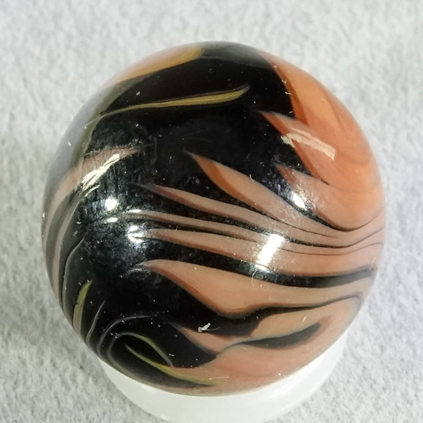 CHRISTENSEN AGATE COMPANY, Flame Swirl. 19/32". Mint (9.9).: CHRISTENSEN AGATE COMPANY, Flame Swirl. Black swirls in red. Many flame tips. Cambridge OH, circa 1925-1930. 19/32". Mint (9.9).