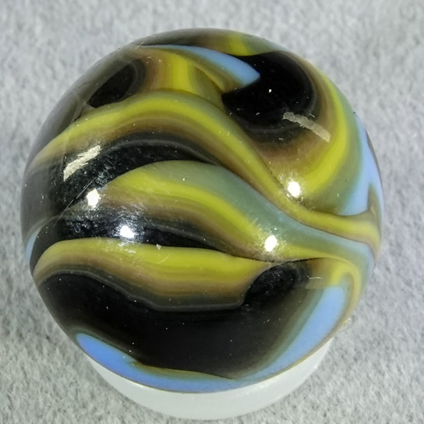 CHRISTENSEN AGATE COMPANY, Flame Swirl. 5/8". Mint (9.9).: CHRISTENSEN AGATE COMPANY, Flame Swirl. Black and yellow swirls in light blue. Great example. Cambridge OH, circa 1925-1930. 5/8". Mint (9.9).