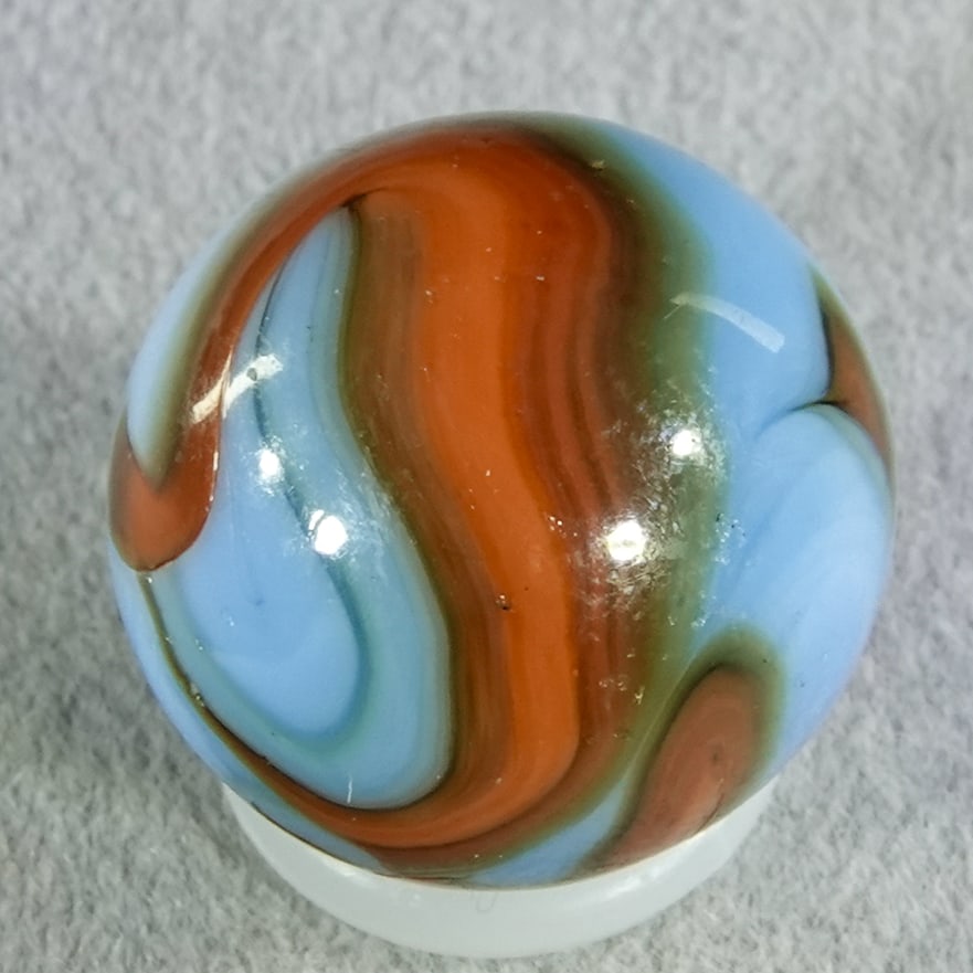 CHRISTENSEN AGATE COMPANY, Swirl. 5/8". Mint (9.8).: CHRISTENSEN AGATE COMPANY, Swirl. Red swirls mixed with gray in blue base. Cambridge OH, circa 1925-1930. 5/8". Mint (9.8).
