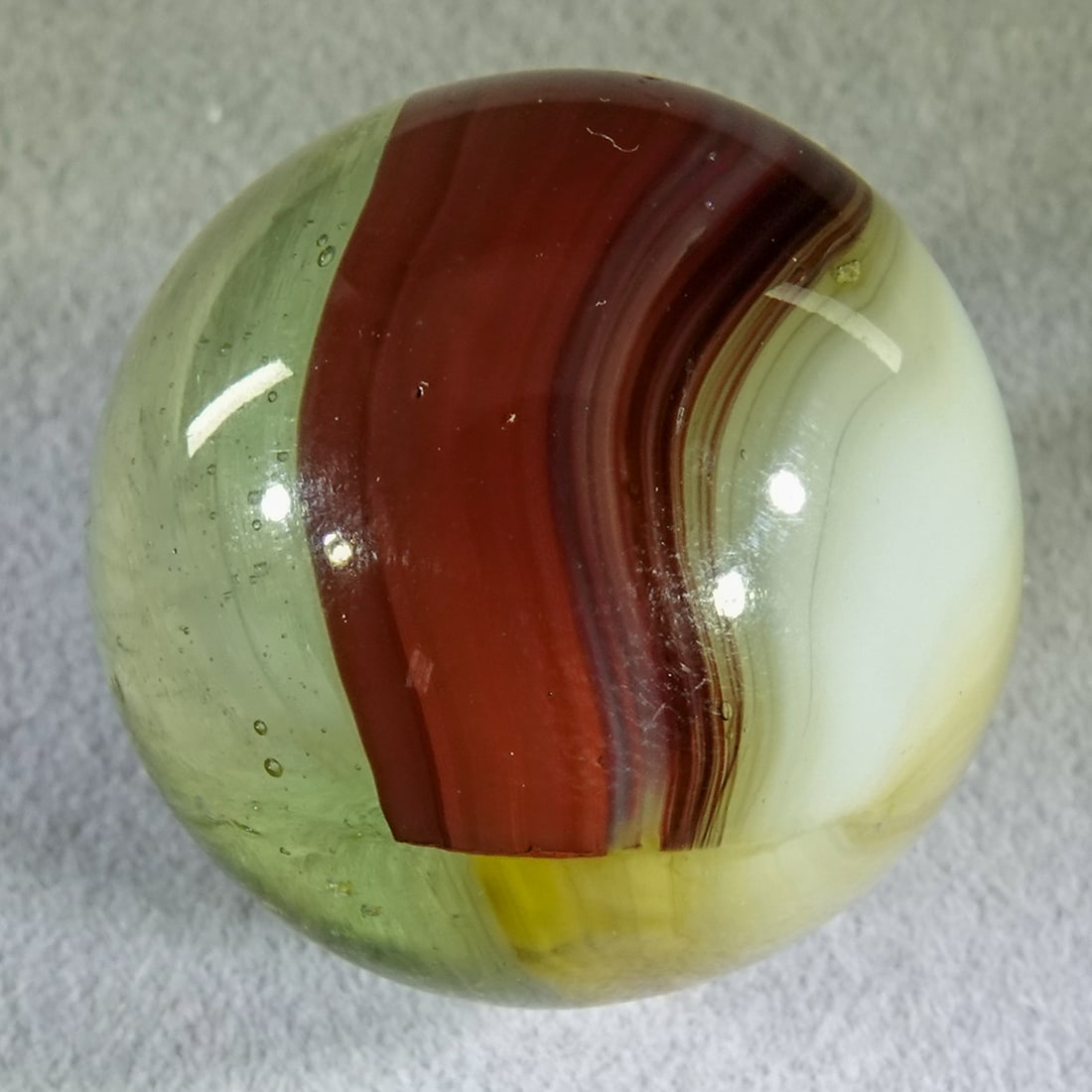 AKRO AGATE COMPANY, Patch Oxblood. 31/32". Mint (9.9). (1 of 6)
