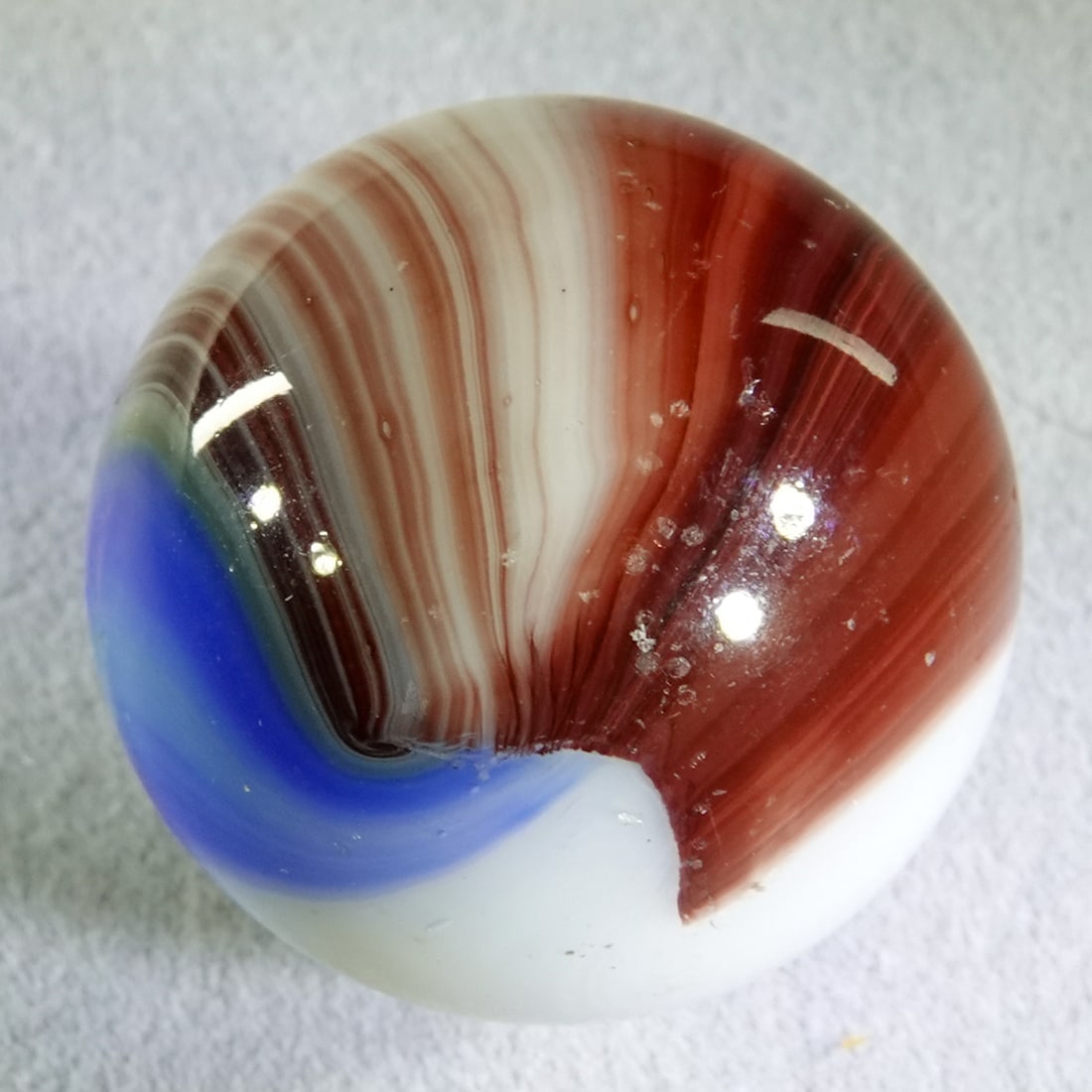 AKRO AGATE COMPANY, Patch Oxblood. 31/32". Mint (9.9). (1 of 6)