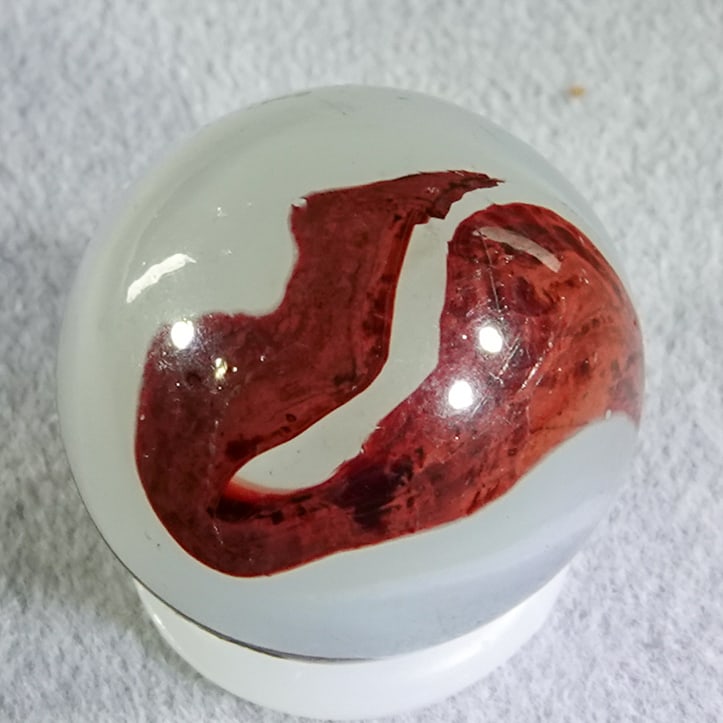 AKRO AGATE COMPANY, Silver Oxblood. 19/32". Mint (9.9).: AKRO AGATE COMPANY, Silver Oxblood. Nice oxblood swirled on a translucent milky white base with some opaque white. Clarksburg WV, circa 1925-1935. ex-collection: Ralph Stagg 19/32". Mint (9.9).
