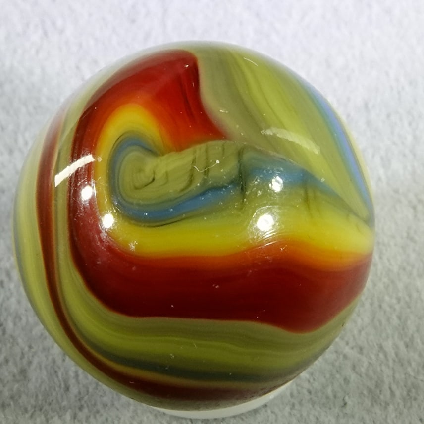 AKRO AGATE COMPANY, Corkscrew. 23/32". Near Mint(+) (8.9).: AKRO AGATE COMPANY, Corkscrew. Interesting Superman Corkscrew. Triple twist. Spirals of red, yellow, blue and mixed blue and yellow. One tiny spot of rubbing Shooter. Clarksburg WV, circa 1925-1935. 2