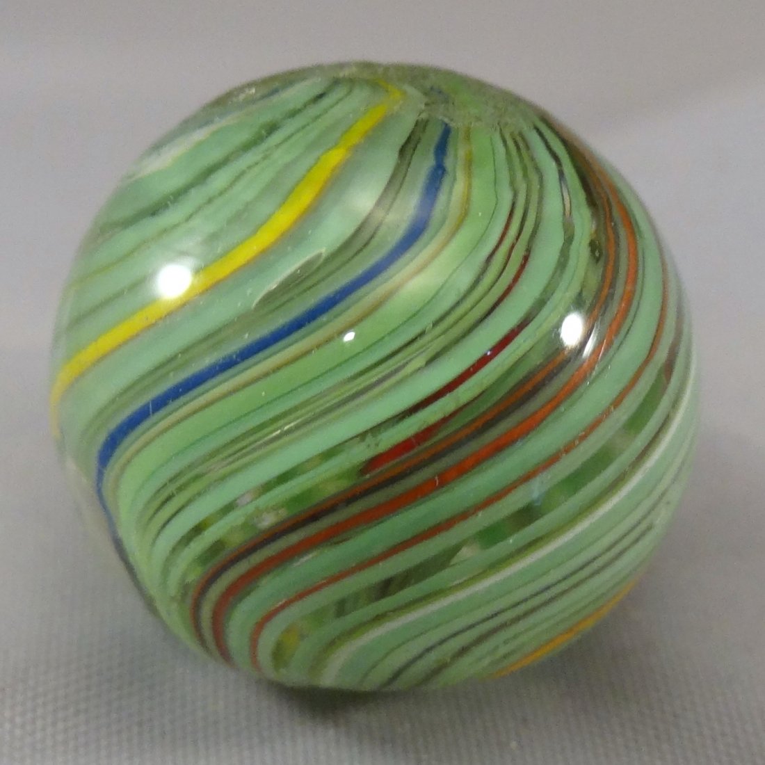 Marbles: Lot 56. SWIRL, Joseph Coat. Mint (9.7). 3/4".: Lot 56. SWIRL, Joseph Coat. Subsurface layer predominately light green with some other colors. Germany, circa 1860-1920. 3/4". Mint (9.7).