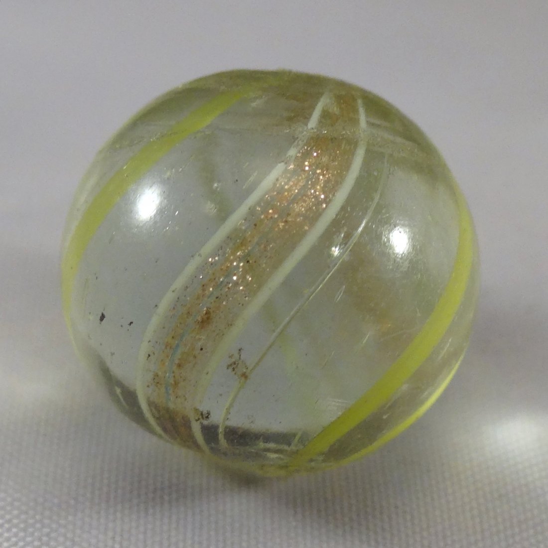Marbles: Lot 64. LUTZ, Banded. Mint (9.7). 21/32".: Lot 64. LUTZ, Banded. Transparent clear base. Four light green bands and two white-edged lutz bands. Nice. Germany, circa 1860-1920. 21/32". Mint (9.7).