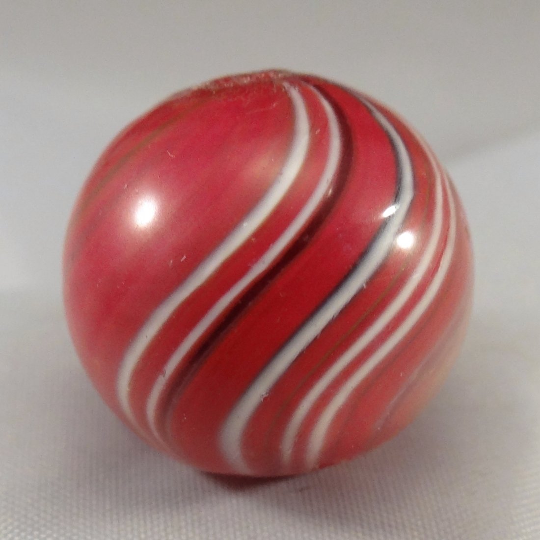 Marbles: Lot 70. SWIRL, Joseph Coat. Mint(-) (9.1).: Lot 70. SWIRL, Joseph Coat. Subsurface layer predominately red with some other colors. One tiny melt spot. Germany, circa 1860-1920. 25/32". Mint(-) (9.1).