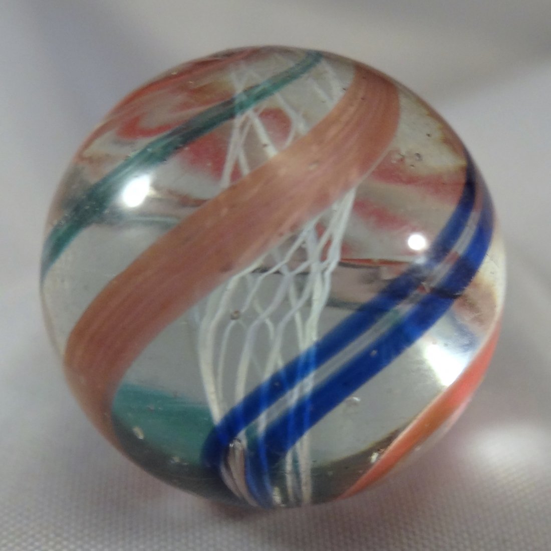 Marbles: Lot 102. SWIRL, Latticinio Core. Mint(-): Lot 102. SWIRL, Latticinio Core. White Latticinio Core Swirl. Very pretty. One tiny pinprick. Germany, circa 1860-1920. 13/16". Mint(-) (9.2).
