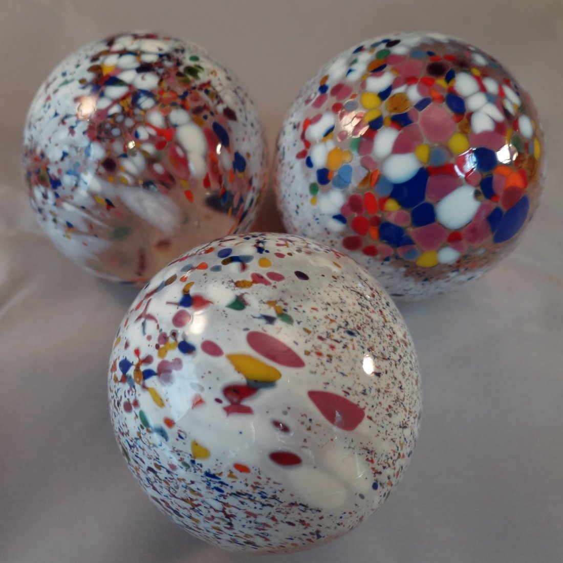 Marbles: Lot 146. CONTEMP Mint (9.9). 1-13/16".: Lot 146. CONTEMPORARY HANDMADE. Lot of three marbles. All are confetti. Each has a window at the bottom so you can peer into the interior. Unsigned, possibly Gentile Glass. Each is 1-13/16" and Mint.