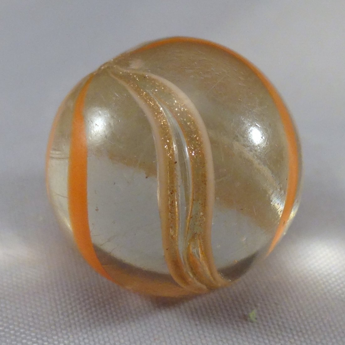 Marbles: Lot 226. LUTZ, Banded. Mint (9.8). 21/32".: Lot 226. LUTZ, Banded. Transparent clear base. Four orange bands, two white-edged lutz bands. A couple of tiny pinpricks. Germany, circa 1860-1920. 21/32". Mint (9.8).