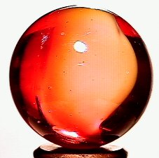 64024 BB Marbles: Peltier Root Beer Float: PELTIER GLASS COMPANY, Root Beer Float. Nova known as the Root Beer Float.Transparent brown marble with wide opaque white ribbon in it. Limited run by Peltier. Ottawa IL,1979. 31/32". Mint (9.9).