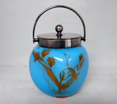 Thomas Webb Sweet Meat: 4" tall blue with gold enameled floral sweet meat. The metal collar and handle are covered by a metal lid signed with English hallmarks. The glass has a highly polished pontil that uncovers the white