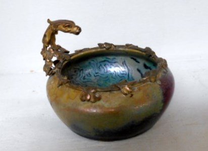 Clement Massier bowl: 4 1/4" diameter iridescent bowl with metal dragon collar and base. Stunning interior and exterior iridescent glaze signed Clement Massier Golfe Juan with two other marks. Museum quality piece simply b