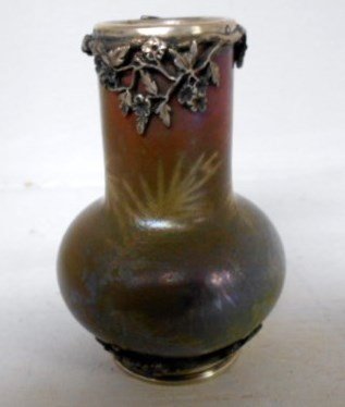 Clement Massier Cabinet Vase: 3 1/2" tall Clement Massier cabinet vase. Ornate silver floral collar and base over a beautifully iridescent fern glaze. Signed C.M. Golfe Juan on base. Another museum quality example of French potter