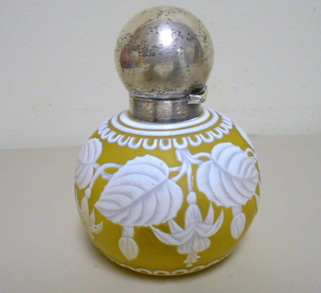Thomas Webb Cameo Perfum Bottle: 4 1/2" Cameo glass perfume bottle with sterling silver collar and lid. Magnificent cameo cut floral and butterfly. Unsigned polished pontil. Museum quality example of Webb cameo.