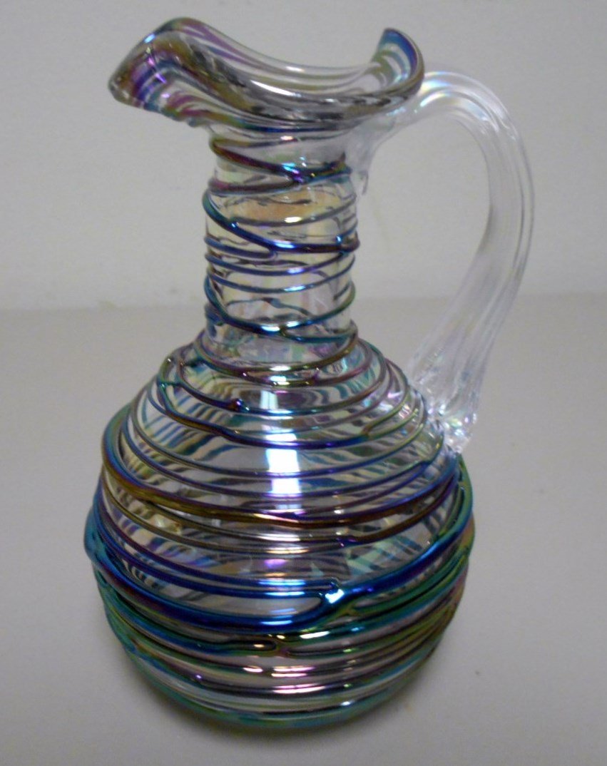 Picker's Lot of Cruets: 5 1/2" contemporary threaded glass cruet with multi colored iridescent threading. Polished unsigned base. 4 3/4" Rosaline and Alabaster cruet with diamond quilting and polished pontil. 7 3/4" Stevens