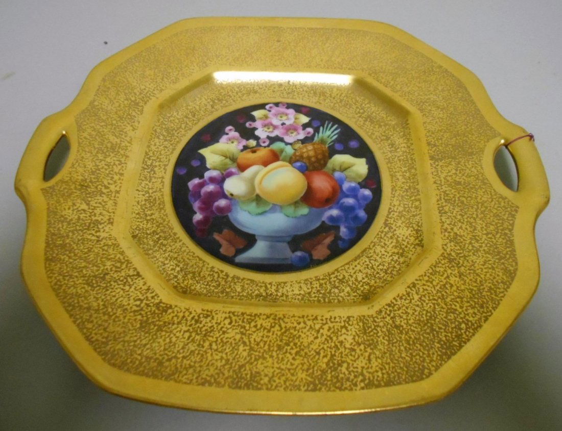 Picard Cake Plate: 10 1/2" diameter Cake plate with painted fruit and all over encrusted gold décor. Artist signed with Picard black mark over gold maple leaf.