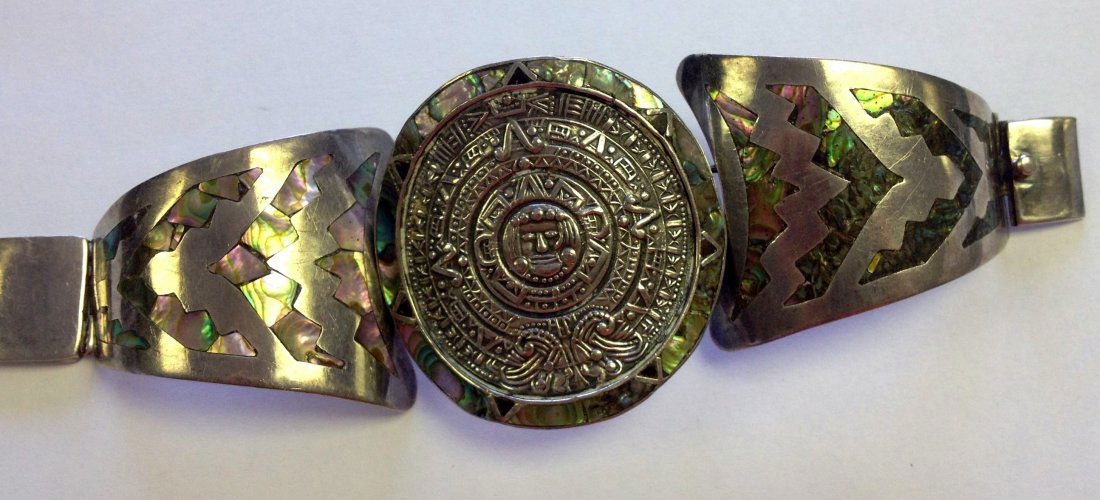Sterling & Abalone Taxco Bracelet: Mid Century Modern Taxco sterling and abalone bracelet stamped Taxco 925 and decorated with the Mayan calendar. Apprx weight 2.5 oz.