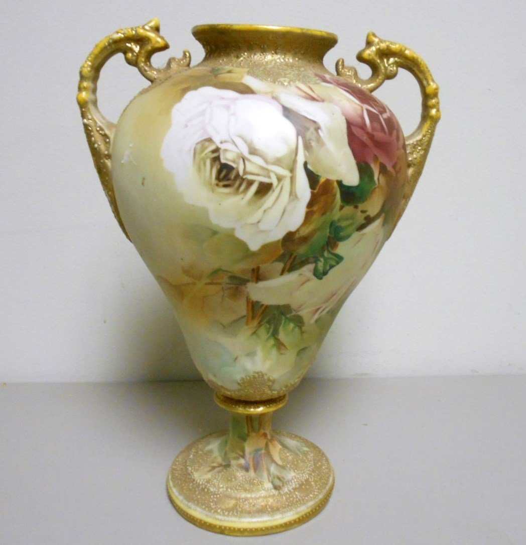 Large Nippon Bolted Vase: 12 1/2" two piece bolted Vase signed with blue mapleleaf mark on base. Double handled with White rose floral motif. Handles collar and base are textured enameling.