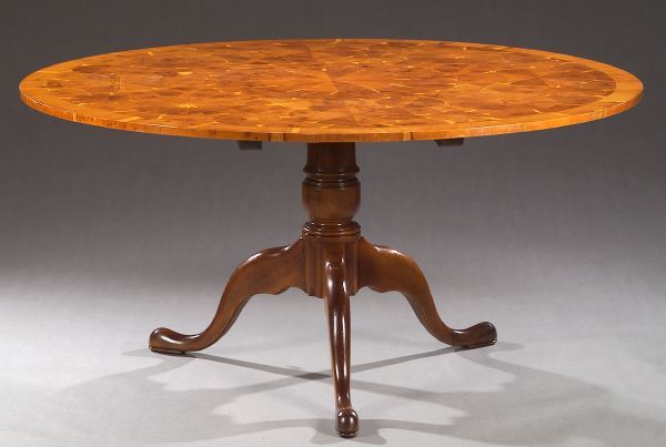 AN ENGLISH QUEEN ANNE STYLE OYSTER-VENEERED YEW W: AN ENGLISH QUEEN ANNE STYLE OYSTER-VENEERED YEW WOOD PEDESTAL DINING TABLE, late 20th century. The circular top above a ring-turne baluster pedestal on cabriole legss with pad feet - 30in. x 60in.