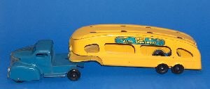 THREE METAL TOY TRUCKS. Including a flat bed truck: THREE METAL TOY TRUCKS. Including a flat bed truck, with cream colored cab and green rising flat bed, marked "Mfd. by Keystone Mfg. Co., Boston, Mass.", 23 in. long; a red Texaco gasoline transport tr