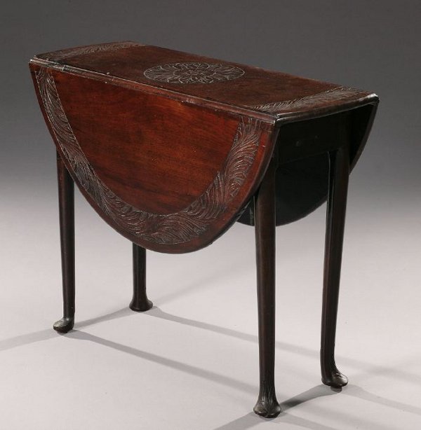 A GEORGE II WALNUT SWING-LEG DROP-LEAF T