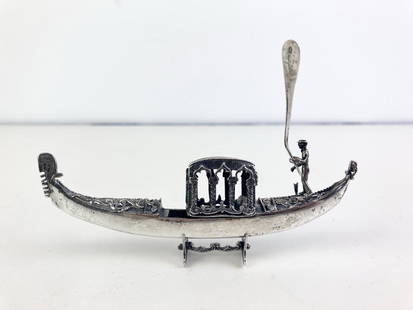 ITALIAN STERLING SILVER (925-FINE) MINIATURE SCULPTED FIGURE OF GONDOLA WITH GONDOLIER.: ITALIAN STERLING SILVER (925-FINE) MINIATURE SCULPTED FIGURE OF GONDOLA WITH GONDOLIER. On separate sterling stand.L: 4 7/8 in. Wt. 1.4 troy oz.