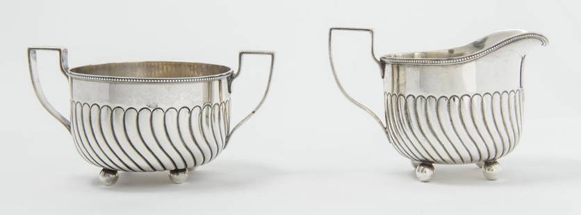 DOMINICK & HAFF STERLING SILVER CREAMER AND OPEN SUGAR, Retailed by Theodore B. Starr, New York,: DOMINICK & HAFF STERLING SILVER CREAMER AND OPEN SUGAR, Retailed by Theodore B. Starr, New York, made in 1882. Circular vessels with swirl reeding; ball feet. Sugar bowl, H: 3 1/8 in.; D: 4 in. Wt.