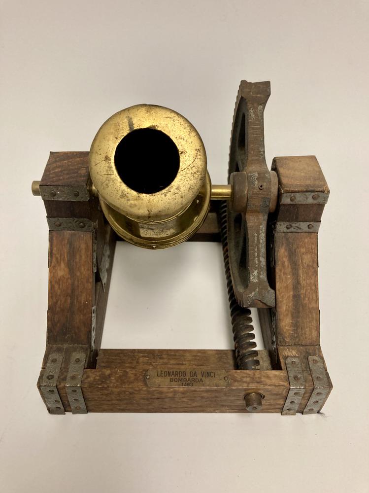 BRASS AND WOOD TABLETOP MODEL OF A BOMBADIER. Affixed with brass plate engraved "Leonarda Da (1 of 6)