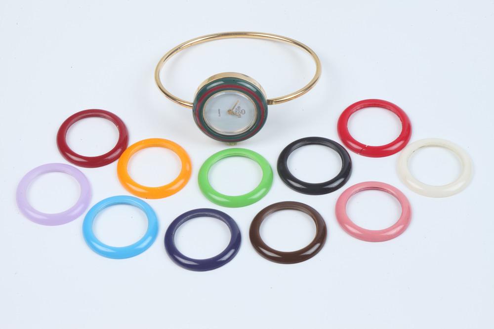 VINTAGE GUCCI OVAL BANGLE-FORM FASHION WATCH WITH TWELVE INTERCHANGABLE COLORED BEZELS, (1 of 1)