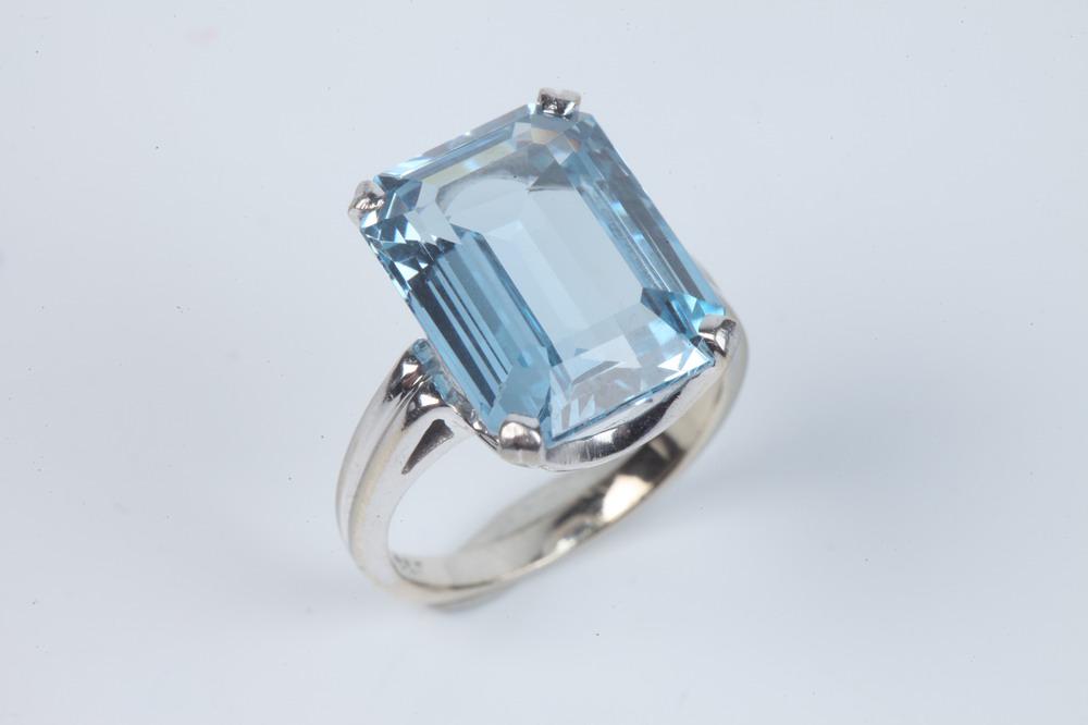 14K WHITE GOLD AND AQUAMARINE RING. Emerald-cut aquamarine weighing 13.23 ct. raised by four prongs. (1 of 1)