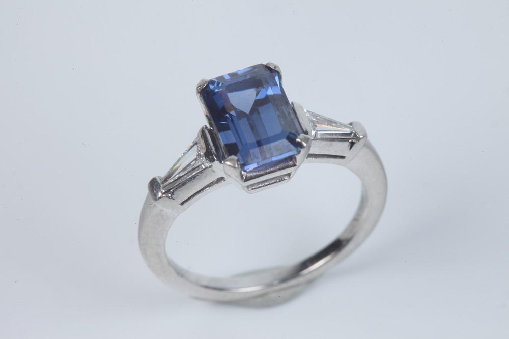 PLATINUM, DIAMOND AND SAPPHIRE RING. Emerald-cut sapphire weighing app. 2.00 ct. raised by four (1 of 1)