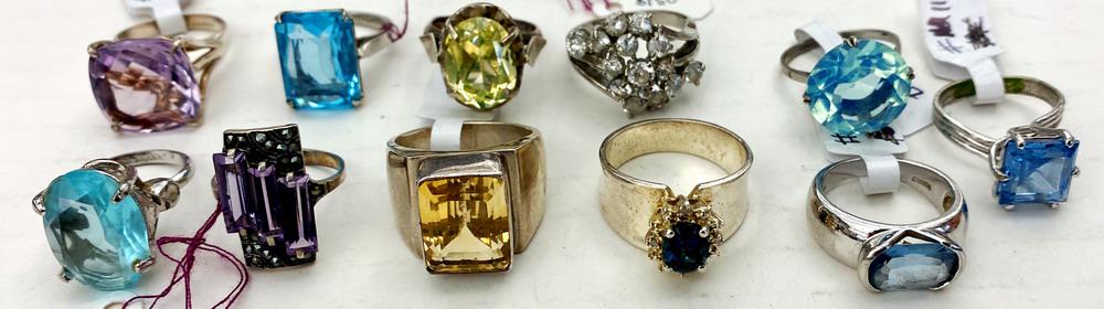 ELEVEN ASSORTED COLORED AND COLORLESS STONE RINGS. (1 of 1)