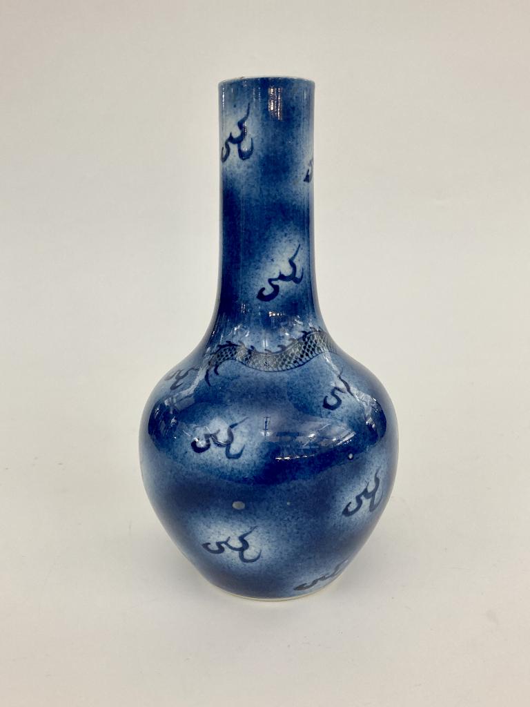 CHINESE BLUE AND WHITE PORCELAIN BOTTLE VASE H: 8 3/4".: CHINESE BLUE AND WHITE PORCELAIN BOTTLE VASE - CHANG SHI. Writhing dragon chasing flaming pearl of wisdom; four-character mark under foot. - H: 8 3/4".