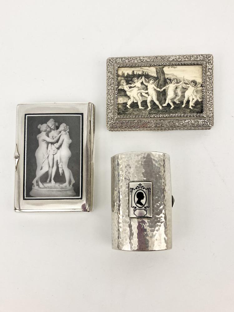THREE ASSORTED SILVER FIGURAL DECORATED CIGARETTE CASES. - Largest, 3 3/4" x 2 3/4"; Gross wt.: 11.4: THREE ASSORTED SILVER FIGURAL DECORATED CIGARETTE CASES. One, Russian, with cover depicting the three graces; one, Continental with scrimshaw decorated panel of cherubs frolicking in landscape; one,