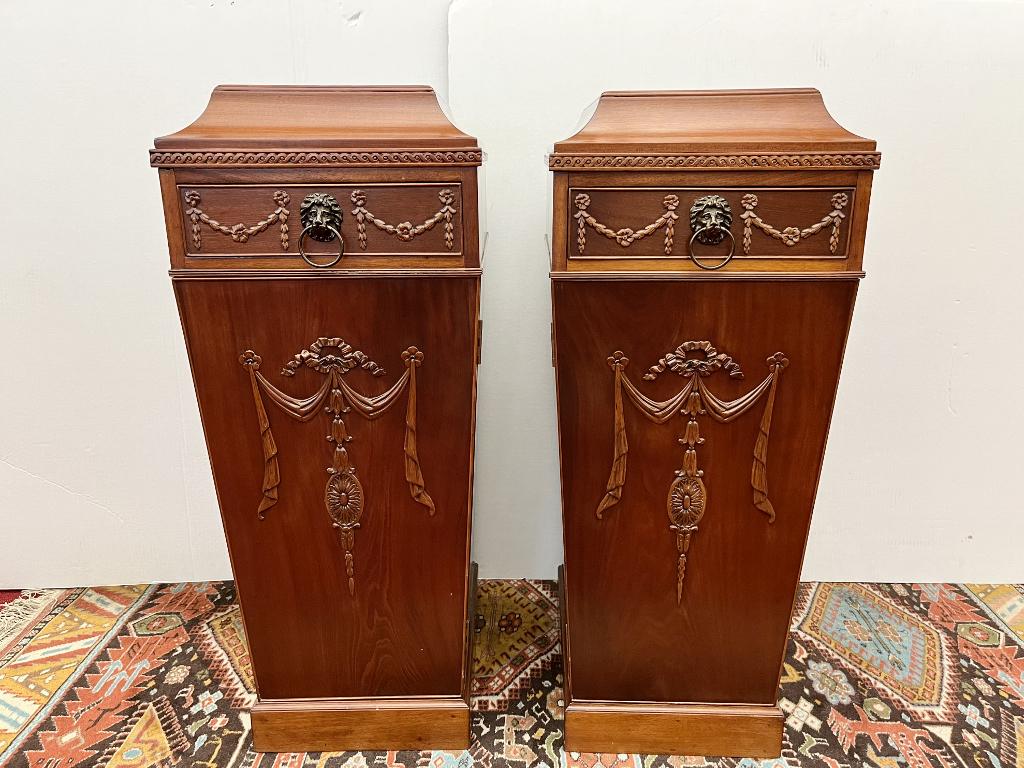 PAIR ADAMS STYLE CARVED MAHOGANY PEDESTALS.: PAIR ADAMS STYLE CARVED MAHOGANY PEDESTALS. Rectangular tops; each has one drawer (one compartmented for silverware storage) over cabinet door; plinth bases; carved with Neoclassical motifsH: 40 in.; 