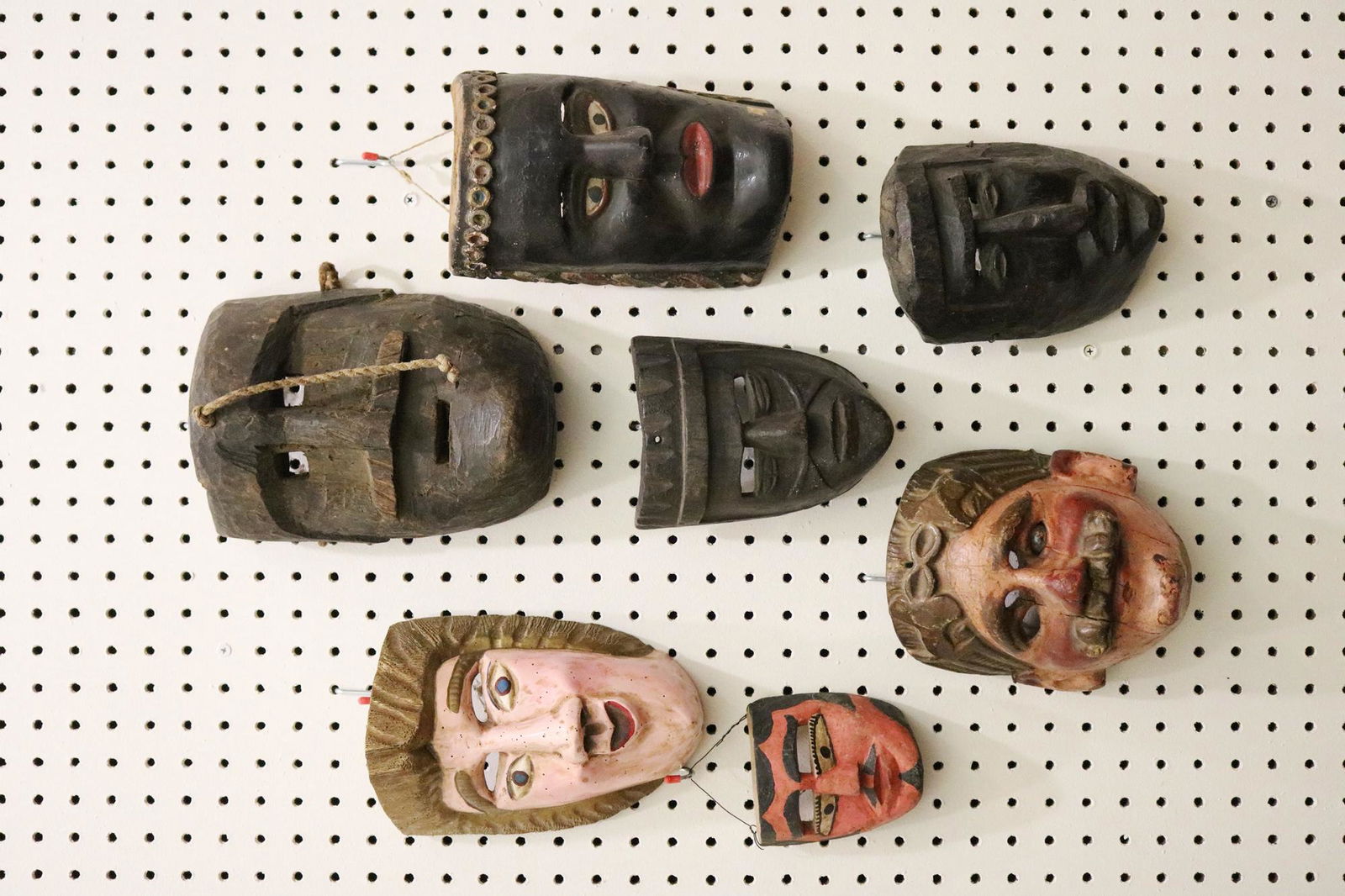 SEVEN GUATEMALAN FESTIVAL CARVED MASKS, Mid-to-late 20th Century. - Height: 10 inches (top mask with: SEVEN GUATEMALAN FESTIVAL CARVED MASKS, Mid-to-late 20th Century. Hand carved and decorated wooden Guatemalan festival masks which are used for traditional dances during festivals. There are signs of