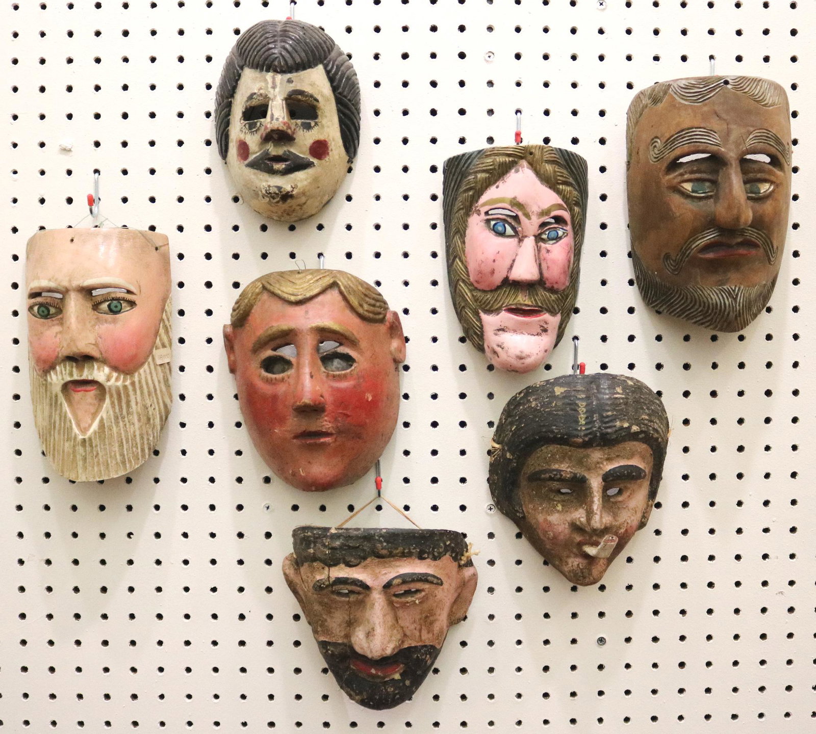 SEVEN GUATEMALAN FESTIVAL CARVED MASKS, Mid-to-late 20th Century. - Height: 9 inches.: SEVEN GUATEMALAN FESTIVAL CARVED MASKS, Mid-to-late 20th Century. Hand carved and decorated wooden Guatemalan festival masks which are used for traditional dances during festivals. There are signs of 