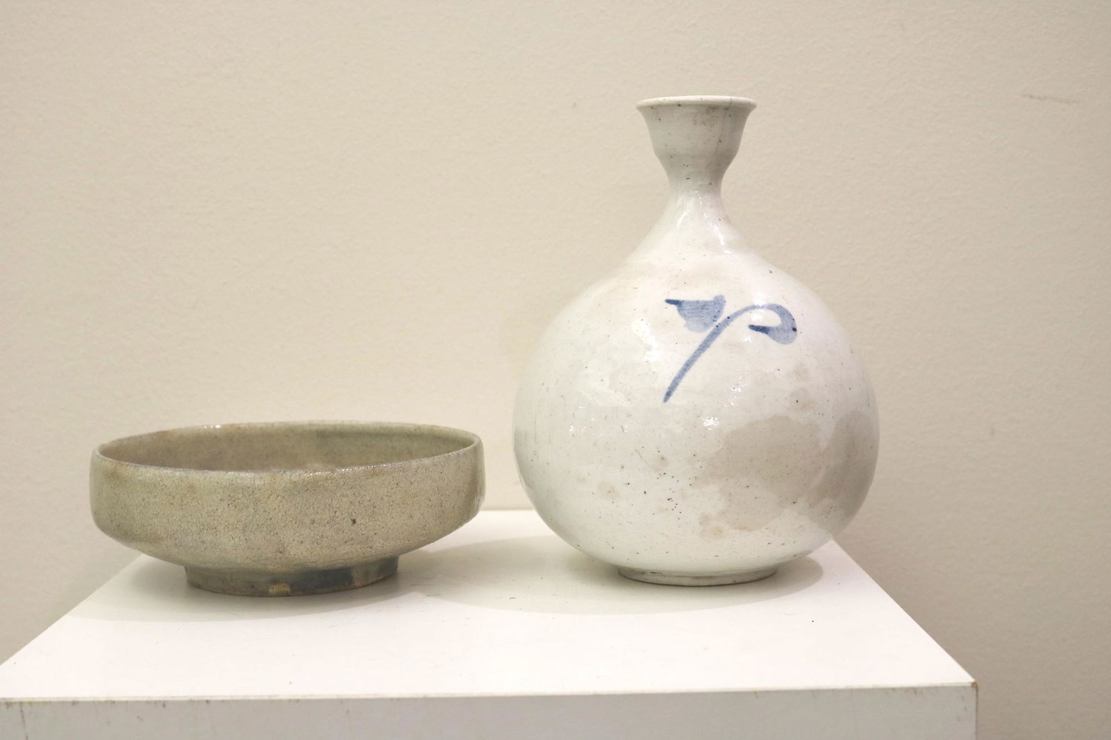 TWO PIECES KOREAN POTTERY. White glazed bottle vase with blue slip decoration; H: 7 1/.4 in. and (1 of 8)