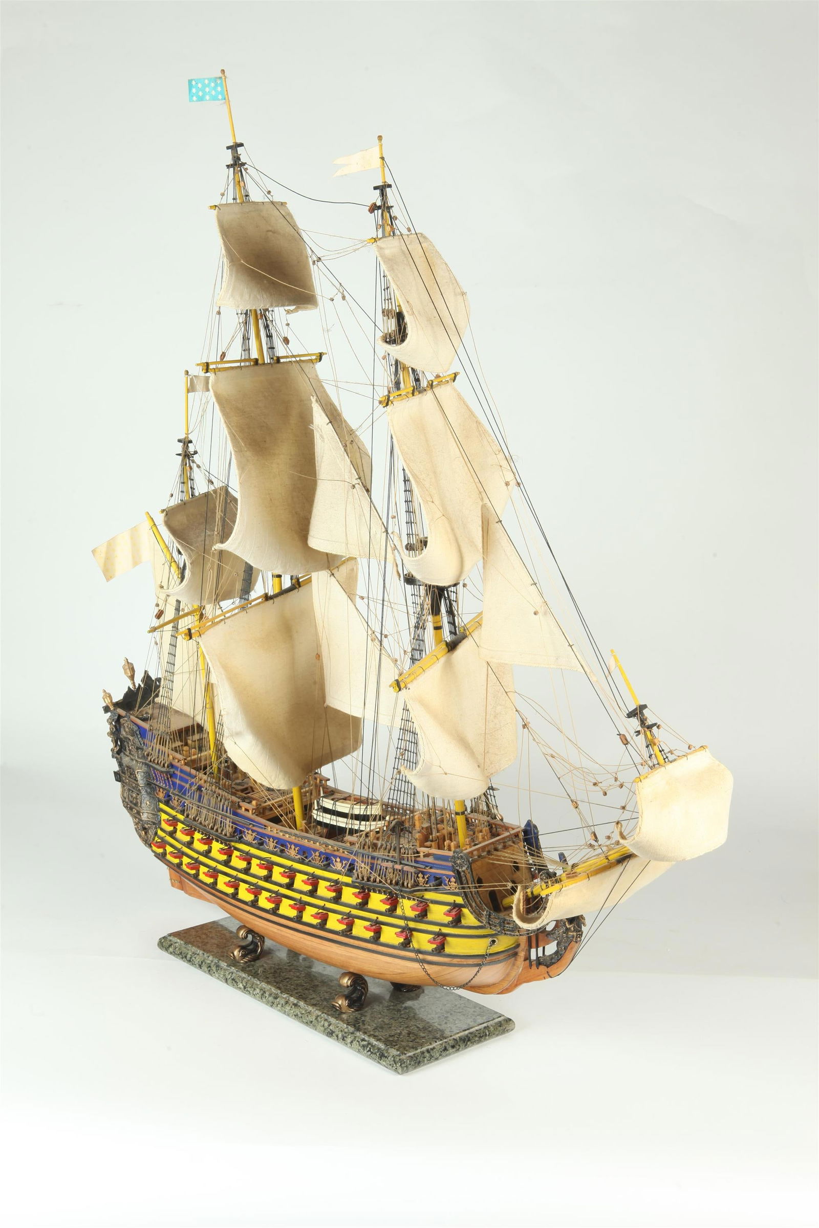 EARLY TO MID 20TH CENTURY CARVED WOODEN SHIP MODEL OF EARLY THREE-MASTED SPANISH GALLEON, - H: 35: EARLY TO MID 20TH CENTURY CARVED WOODEN SHIP MODEL OF EARLY THREE-MASTED SPANISH GALLEON. Elaborate rigging; cloth sails; finely carved details; raised on marble plith base. - H: 35 1/2"; L: 32", ove
