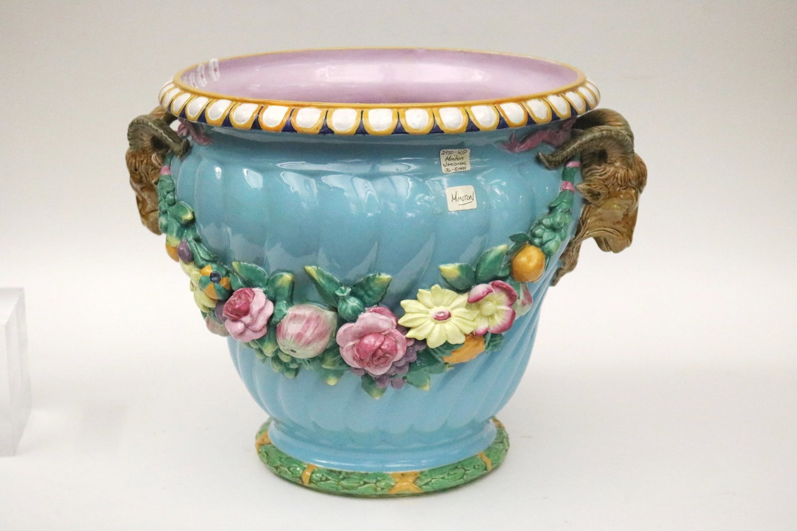MINTON MAJOLICA JARDINIERE. - H: 14 3/4 in. D: 16 in.: MINTON MAJOLICA JARDINIERE. Aqua ground with polychrome floral swags; ram's head handles. - H: 14 3/4 in. D: 16 in.