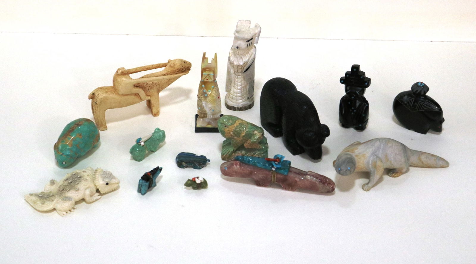 15 NATIVE AMERICAN CARVINGS.: 15 NATIVE AMERICAN CARVINGS. Selection of 15 Native American small-sized carvings. Most carvings depict animals; materials used include clay, jet, shell, coral, and travertine, fishrock, jasper, pipe