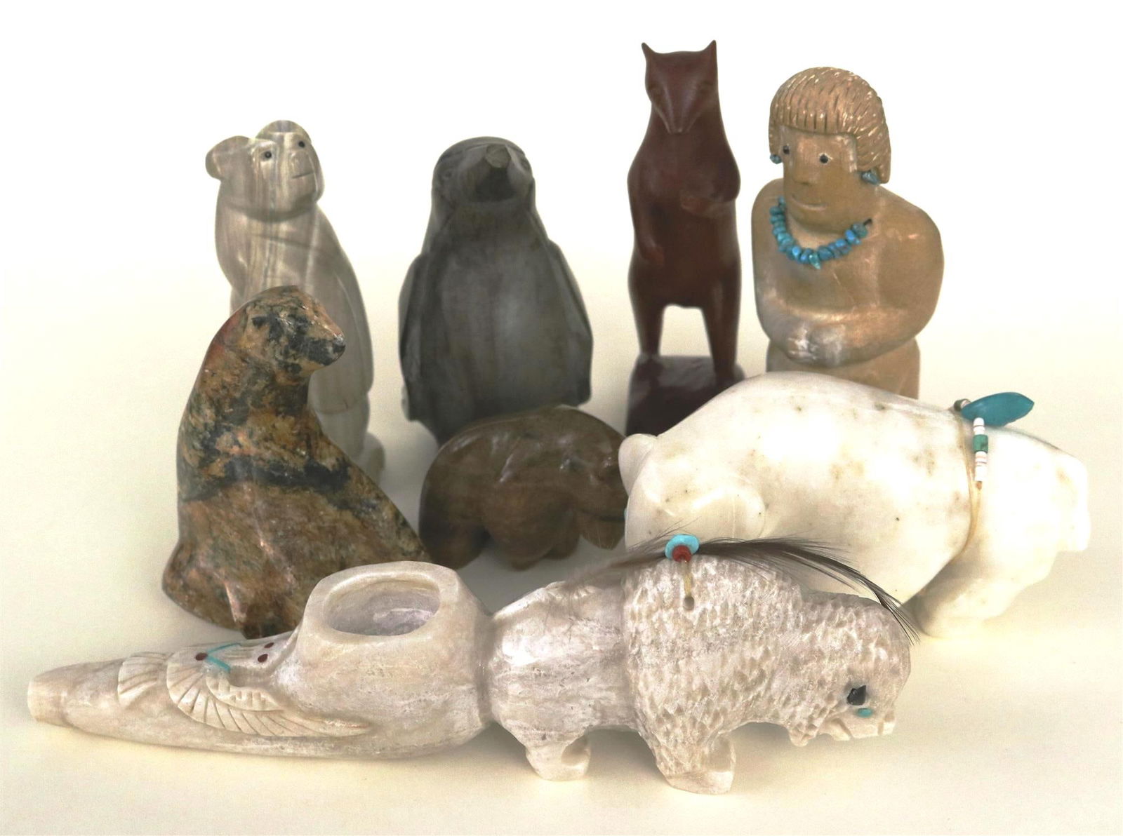 NINE NATIVE AMERICAN CARVINGS,: NINE NATIVE AMERICAN CARVINGS. Selection of 9 Native American small-and-medium-sized carvings. Most carvings depict animals; materials used include jet, shell, malachite, coral, travertine, glass, cl