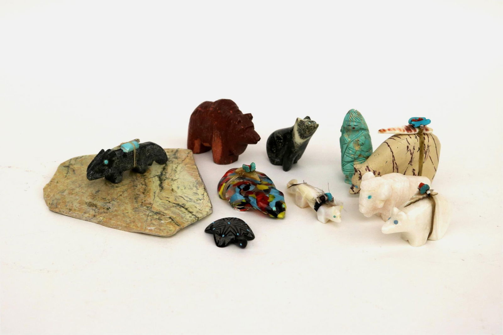 TEN NATIVE AMERICAN CARVINGS,: TEN NATIVE AMERICAN CARVINGS. Selection of 10 Native American small-and-medium-sized carvings. Most carvings depict animals; materials used include jet, shell, malachite, coral, travertine, glass, cl