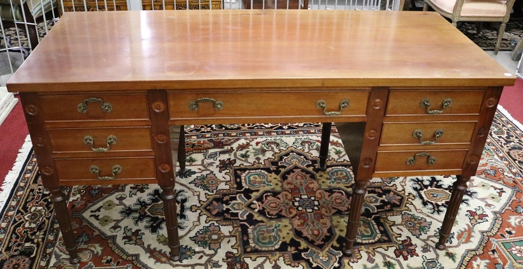 MAHOGANY WRITING DESK, early 20th century. - H: 20 in.; W;: 60 in.; D: 26 in.: MAHOGANY WRITING DESK, early 20th century. Front with seven drawers reverses to seven blind drawers; carved medallion decoration - H: 20 in.; W;: 60 in.; D: 26 in.