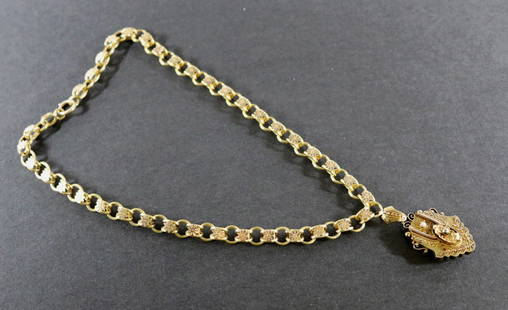 LATE 19TH CENTURY VICTORIAN YELLOW GOLD CARTOUCHE SHAPE LOCKET SUSPENDED ON DETACHABLE VICTORIAN: LATE 19TH CENTURY VICTORIAN YELLOW GOLD CARTOUCHE SHAPE LOCKET SUSPENDED ON DETACHABLE VICTORIAN OVAL-LINK CHAIN WITH FLORAL MOTIFS. circa 1880, Locket decorated with leafy branches, geometric motifs