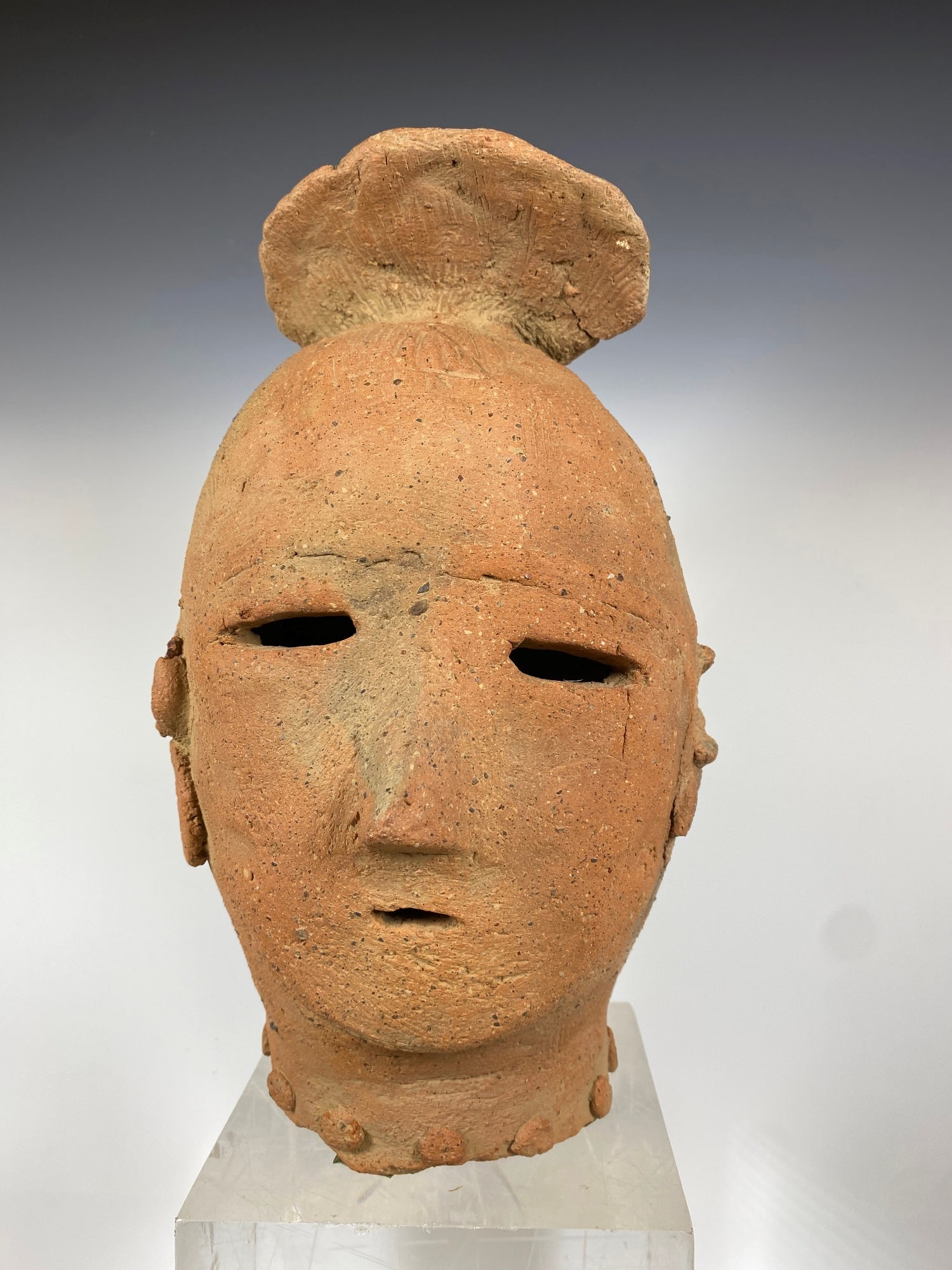 JAPANESE HANIWA CLAY SCULPTURE OF SHRINE ATTENDANT, 3rd-7th century. - Height: 10.75 inches.: JAPANESE HANIWA CLAY SCULPTURE OF SHRINE ATTENDANT, 3rd-7th century. Fired clay hand-made hollow figure of shrine attendant. Face consists of three slit-type openings for eyes and mouth; nose, forehea