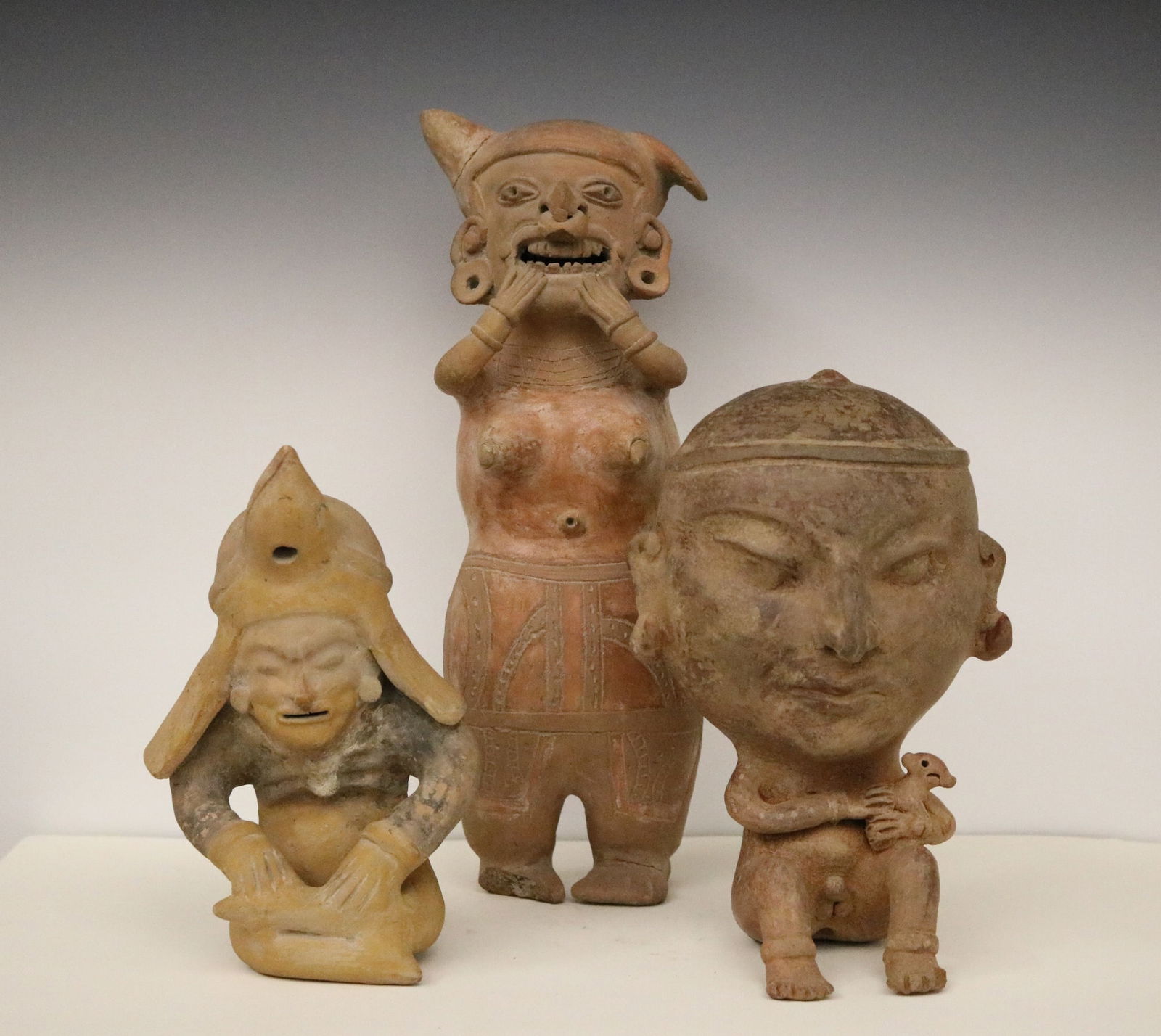 THREE PRE-COLUMBIAN STYLE CERAMIC STATUES, Three terra cotta and ceramic decorated and incised (1 of 17)