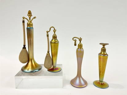THREE GOLD FAVRILE PERUME ATOMIZERS AND ONE PERFUME BOTTLE, early 20th century. - Tallest, H: 9 3/4: THREE GOLD FAVRILE PERUME ATOMIZERS AND ONE PERFUME BOTTLE, early 20th century. One signed DeVilbiss - Tallest, H: 9 3/4 in.