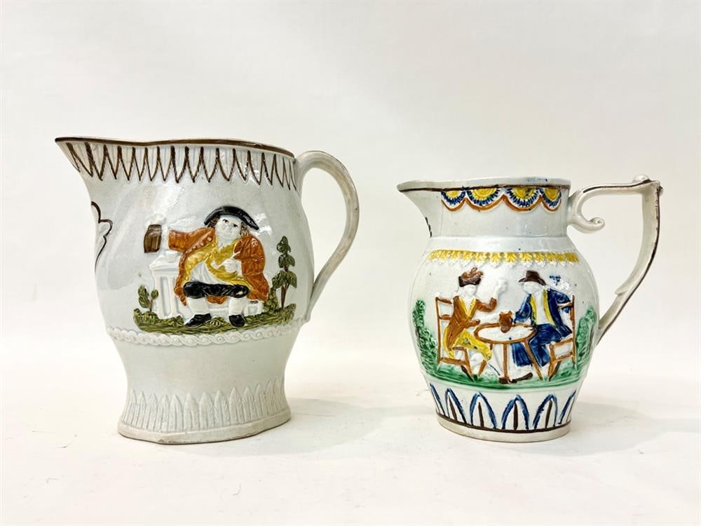 TWO PRATTWARE POLYCHROMED POTTERY PITCHERS WITH FIGURES IN RELIEF DRINKING, SMOKING AND MERRYMAKING, (1 of 6)